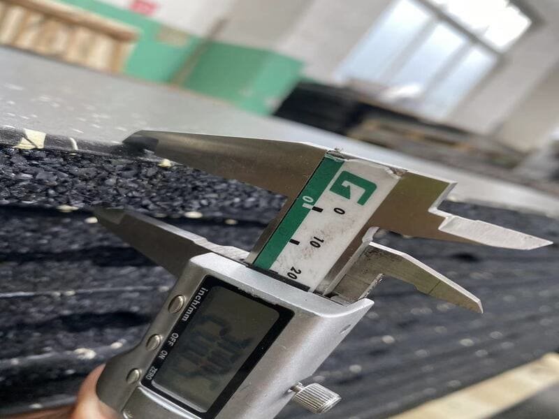 Warehouse worker scanning a barcode on a roll of gym flooring to ensure batch traceability